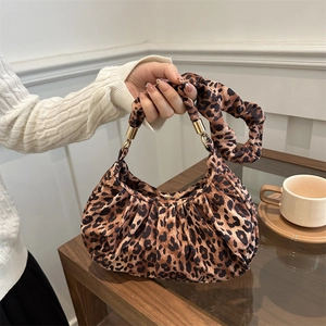 Fashionable leopard print pleated underarm bag with gold hardware and knotted handle
