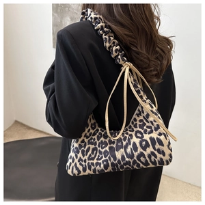 Detail of leopard print tote bag featuring a ruched scrunchie strap and tie-up design