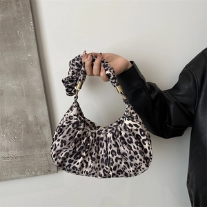 Chic leopard print underarm bag with pleated fabric texture and gold buckle details