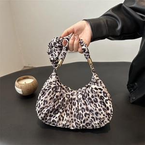 Stylish leopard print pleated shoulder bag with oversized handle and gold metal hardware