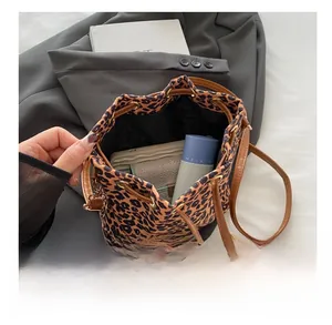 Interior view of leopard print bucket bag showing capacity for wallet and cosmetics