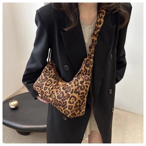 Detail of leopard print tote bag featuring a trendy scrunchie handle and soft velvet texture