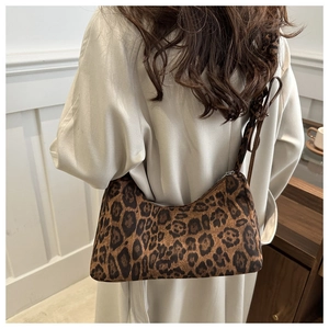 Leopard print baguette shoulder bag shown on model with vintage aesthetic style
