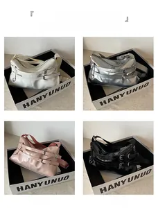 Glossy leather shoulder bags in white, silver, pink, and black with buckle details