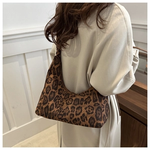 Close-up of leopard print tote bag with soft faux fur texture on beige trench coat