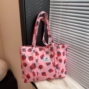 Pink tote bag with red strawberry prints and a stylish minimalist design for women