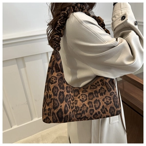 Detail of leopard print tote bag with ruched cloud handle and plush texture fabric