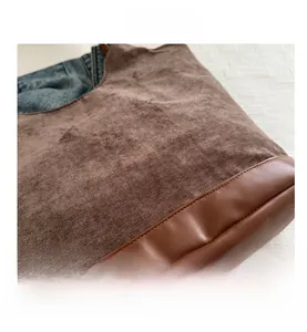 Detail view of the brown corduroy tote bag showing large capacity and textured fabric
