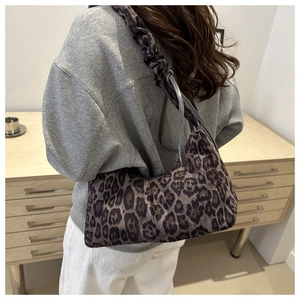 Detail of vintage leopard print hobo bag with trendy scrunchie strap and soft texture