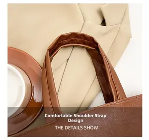 Close-up of comfortable brown leather shoulder strap with neat stitching on tote bag
