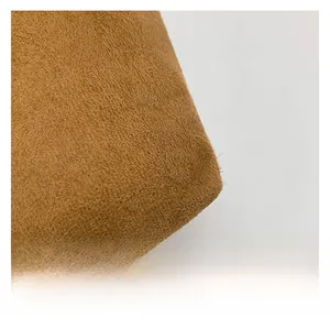 Detailed close-up showing the soft brushed texture of the brown suede tote bag fabric