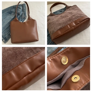 Detail of a brown tote bag showing mixed textures with suede and smooth leather finishes