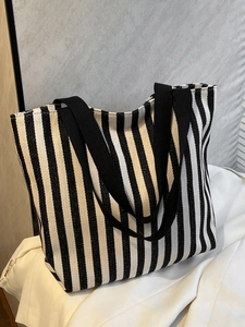 Close-up of thick canvas fabric texture and vertical stripes on the large tote bag