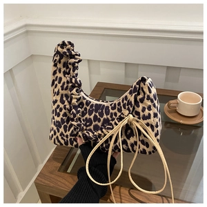 Detail of leopard print tote bag featuring ruffled edges and delicate side bow tie
