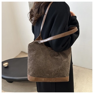 Detail of vintage brown corduroy tote bag with leather straps and base for autumn winter