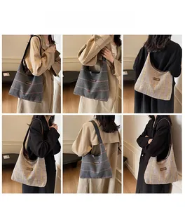 Detail view of large plaid canvas tote bag showing check pattern and shoulder strap style