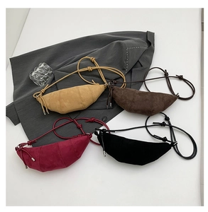 Macro shot of minimalist crescent crossbody bags in suede-like frosted fabric multiple colors
