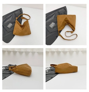 Detail view showing brown matte suede hobo bag with knotted wide shoulder strap