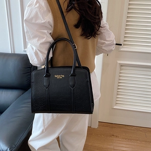 Minimalist black crocodile pattern tote bag with gold lettering and detachable strap