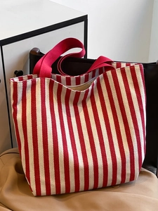 Close-up of red and white striped canvas tote bag showing woven texture and sturdy handles