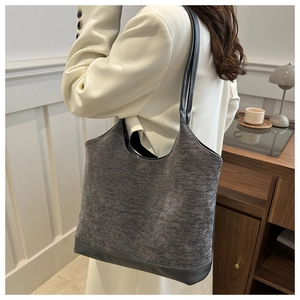 Gray felt tote bag with leather handles shown in a cozy minimalist home interior