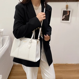 Chic white crocodile embossed tote bag with gold lettering and top handles for commuting