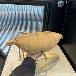 Khaki suede crescent shoulder bag with multi-panel stitching and silver zipper detail