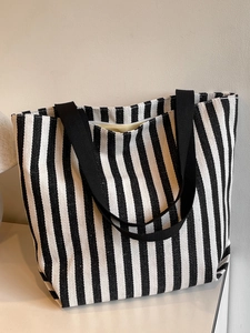 Detailed close-up of thick canvas material with vertical black and white stripe pattern