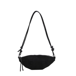 Minimalist black croissant bag in matte fabric with curved stitching and knot shoulder strap