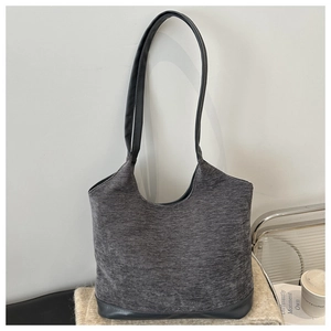 Detail of grey fabric tote bag with premium leather straps and reinforced bottom base