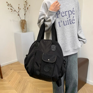 Minimalist black large capacity waterproof nylon backpack with multi-pocket design for travel