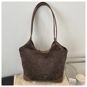 Detailed texture of dark brown corduroy tote bag with premium leather trim and straps