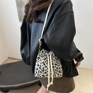 Minimalist leopard print bucket bag with drawstring closure and slim shoulder strap for women