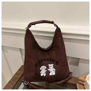 Close-up of cute dog embroidery on dark brown suede tote bag with leather straps