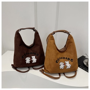 Detailed embroidery of cute animals and letters on suede hobo bags in brown and yellow