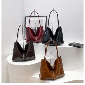 Minimalist tote bags in four rich colors displayed on modern geometric stands for women
