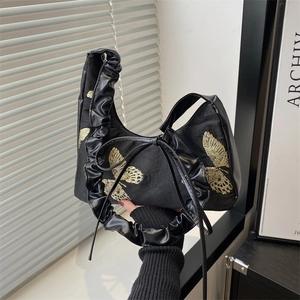 Elegant black shoulder bag with gold butterfly embroidery and pleated handle details