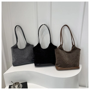 Three textured large capacity tote bags in grey black and brown on a white pedestal