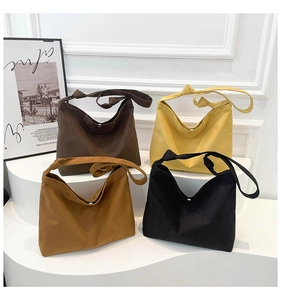 Detail of the unique shoulder strap knot and metal snap button on matte tote bags