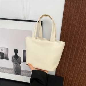 Minimalist beige square tote bag made of soft faux leather for casual winter commuting