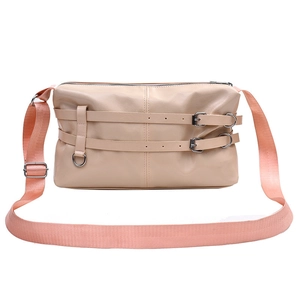 Minimalist beige shoulder bag with pink strap and decorative leather buckles