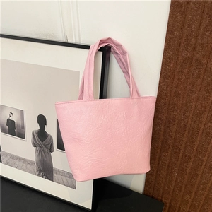 Pink pleated leather tote bag for women featuring minimalist aesthetic and soft shoulder straps