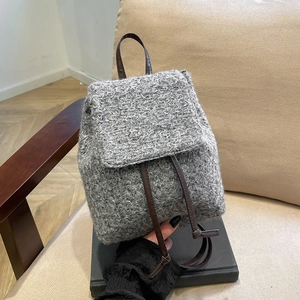 Gray textured wool mini backpack with brown leather straps and vintage drawstring closure