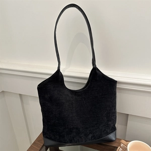 Minimalist black corduroy tote bag with leather base for winter commuting style