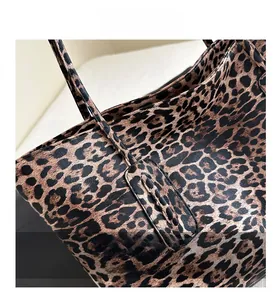 Close-up of leopard print tote bag texture with detailed stitching and leather finish