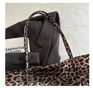 Detail of wide leopard print strap on vintage tote bag with high-quality stitching