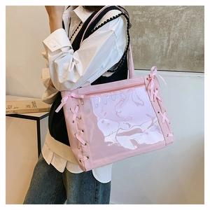 Pink ita-bag tote side view with clear PVC window and decorative ribbon bow details
