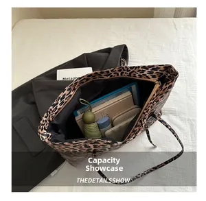 Macro view of leopard print tote bag interior showing large capacity for daily essentials