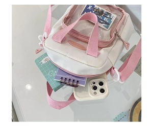 Detail view of pink ita bag featuring transparent window for anime badges and cards