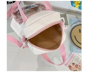 Detail view of the mini ita bag's spacious interior and pink detachable shoulder strap